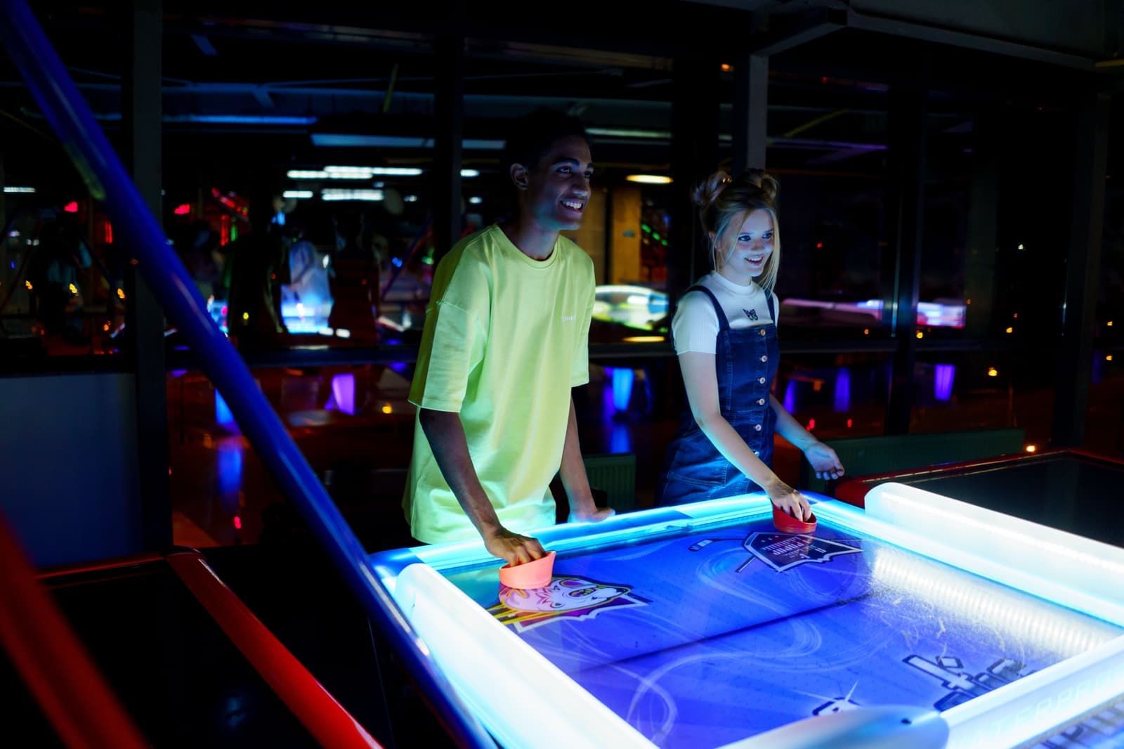 An air hockey table with a lit playfield